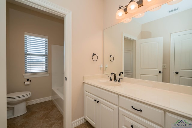 bathroom featuring tile patterned floors, toilet, a bathtub, and vanity