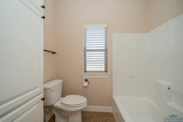 bathroom featuring toilet, tile patterned flooring, and shower with separate bathtub