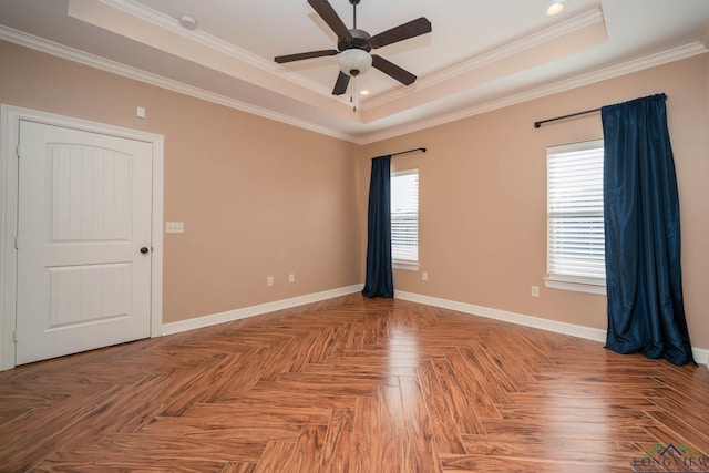 spare room featuring ceiling fan, parquet flooring, and a raised ceiling