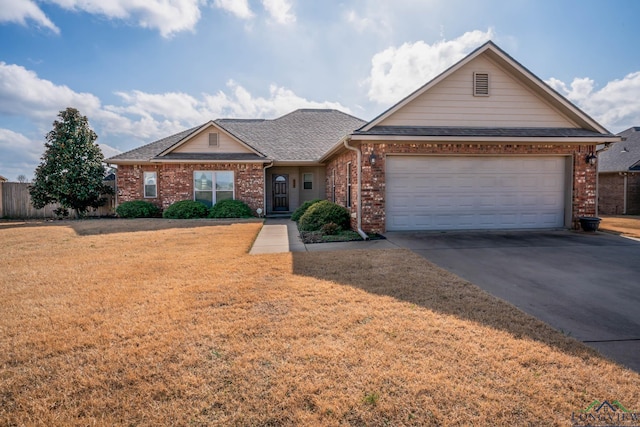 ranch-style house with a garage and a front lawn