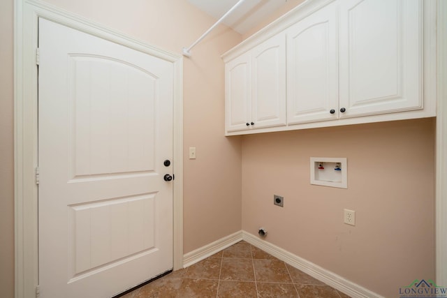 clothes washing area with cabinets, washer hookup, dark tile patterned floors, and electric dryer hookup