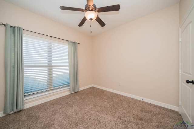 spare room featuring ceiling fan and carpet