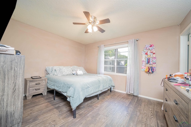 1605 Clearwood Dr, Longview, TX 75604 - bedroom featuring wood finished floors, a ceiling fan, and a textured ceiling