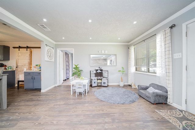 1605 Clearwood Dr, Longview, TX 75604 - sitting room with a barn door, recessed lighting, wood finished floors, and ornamental molding