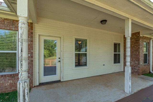 107 Lakeway Ln, Longview, TX 75604 - view of exterior entry featuring a patio area and brick siding