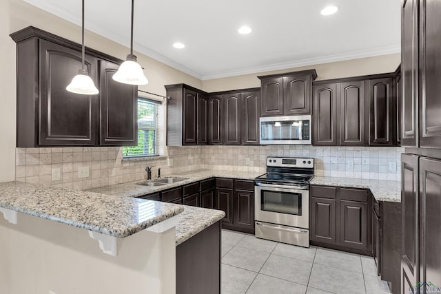 107 Lakeway Ln, Longview, TX 75604 - kitchen with stainless steel appliances, a peninsula, dark brown cabinetry, a sink, and light tile patterned floors