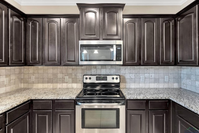 107 Lakeway Ln, Longview, TX 75604 - kitchen with appliances with stainless steel finishes, dark brown cabinetry, decorative backsplash, light stone countertops, and ornamental molding