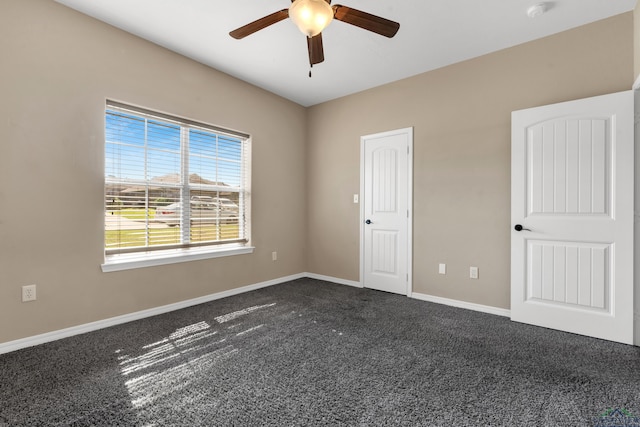 107 Lakeway Ln, Longview, TX 75604 - empty room with a ceiling fan, dark colored carpet, and baseboards