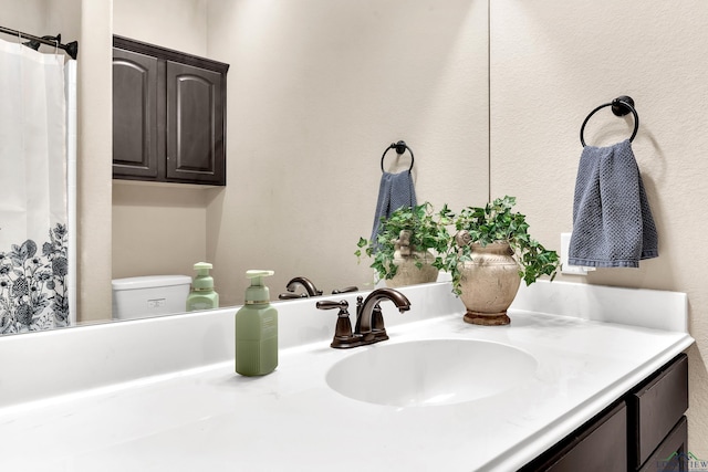 107 Lakeway Ln, Longview, TX 75604 - bathroom with vanity, toilet, and a textured wall