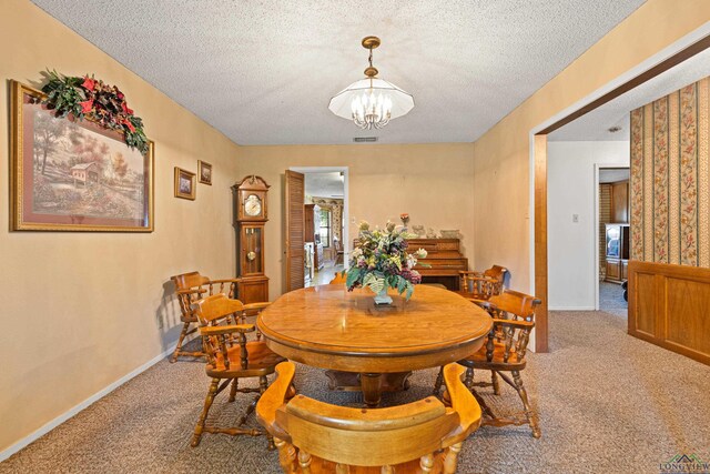 1205 Tiffany Ln, Longview, TX 75604 - dining space with carpet floors, a chandelier, and a textured ceiling