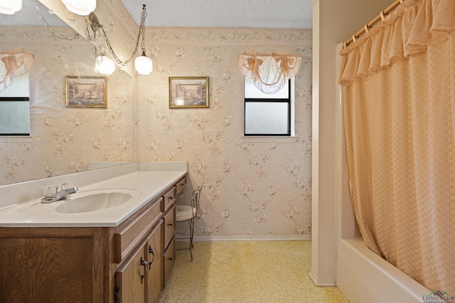 1205 Tiffany Ln, Longview, TX 75604 - bathroom featuring vanity, shower / tub combo with curtain, tile patterned floors, wallpapered walls, and a textured ceiling