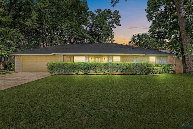 1205 Tiffany Ln, Longview, TX 75604 - single story home featuring a garage, a yard, concrete driveway, and brick siding