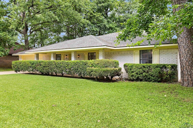 1205 Tiffany Ln, Longview, TX 75604 - single story home with an attached garage, a front yard, a shingled roof, and brick siding