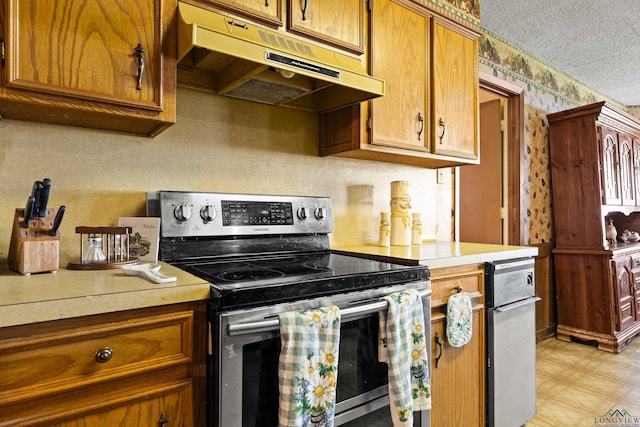 1205 Tiffany Ln, Longview, TX 75604 - kitchen with stainless steel range with electric stovetop, under cabinet range hood, light countertops, brown cabinets, and a textured ceiling