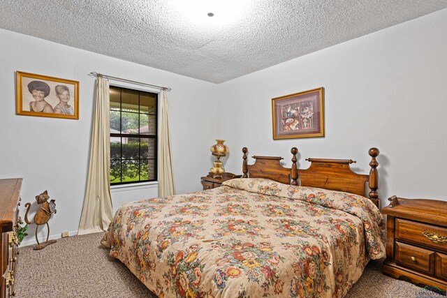 1205 Tiffany Ln, Longview, TX 75604 - carpeted bedroom featuring a textured ceiling and baseboards