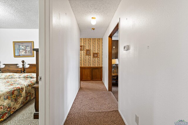 1205 Tiffany Ln, Longview, TX 75604 - hall featuring carpet flooring, a textured ceiling, and wallpapered walls