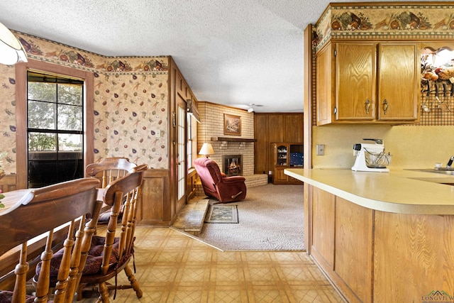1205 Tiffany Ln, Longview, TX 75604 - dining area featuring a textured ceiling, a fireplace, and light flooring