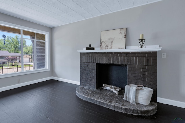 1207 Lettie St, Longview, TX 75601 - detailed view of wood finished floors, a brick fireplace, and baseboards