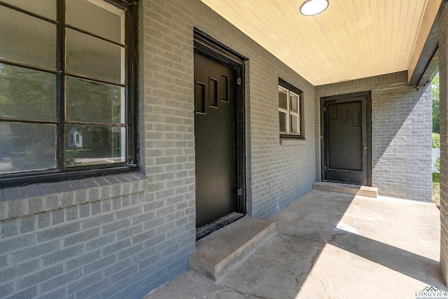 1207 Lettie St, Longview, TX 75601 - view of exterior entry featuring covered porch and brick siding