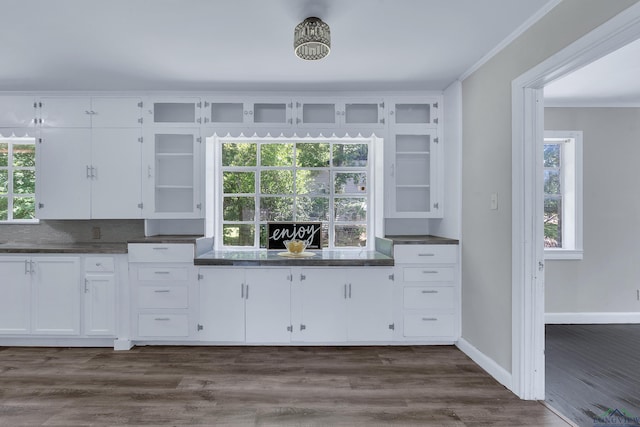 1207 Lettie St, Longview, TX 75601 - kitchen featuring ornamental molding, white cabinetry, dark countertops, and glass insert cabinets