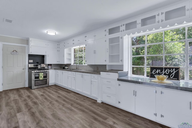 1207 Lettie St, Longview, TX 75601 - kitchen with double oven range, a sink, open shelves, white cabinets, and ornamental molding