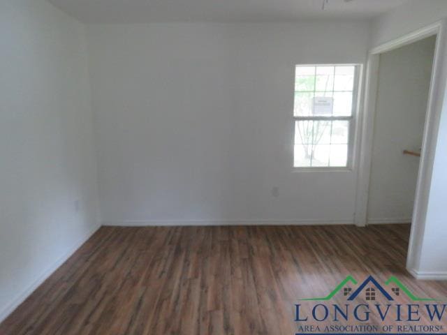 unfurnished room with dark hardwood / wood-style floors