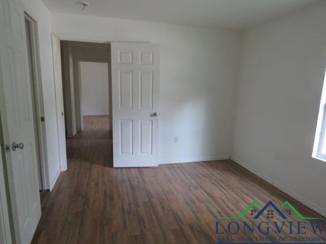 unfurnished room featuring dark wood-type flooring