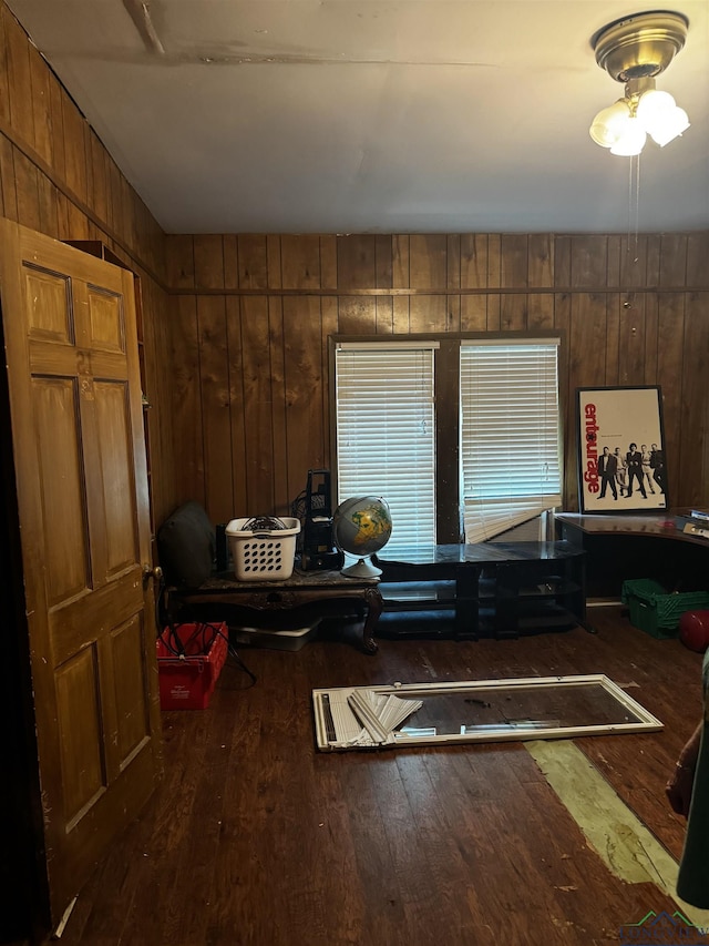 miscellaneous room with dark wood-type flooring and wooden walls