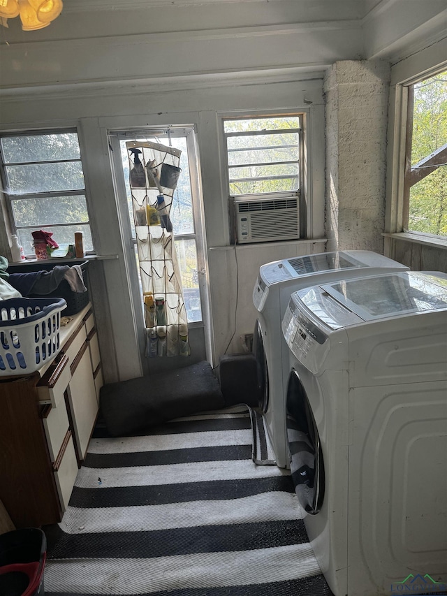 clothes washing area featuring washer and dryer and cooling unit