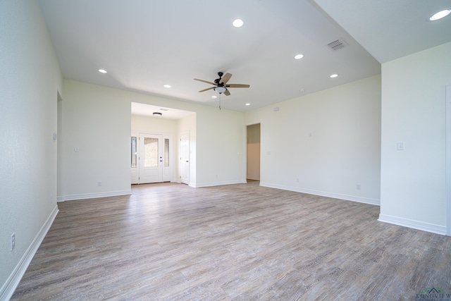 empty room with ceiling fan and light hardwood / wood-style floors