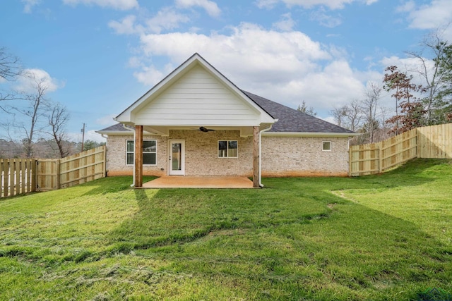 rear view of house with a lawn, ceiling fan, and a patio area