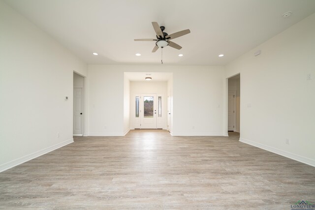 unfurnished living room featuring light wood-type flooring and ceiling fan