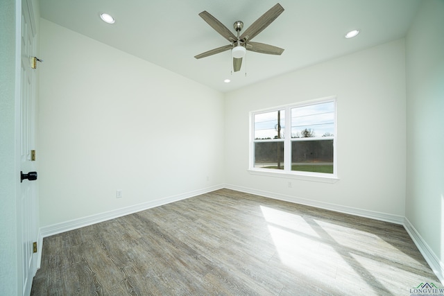 spare room with wood-type flooring and ceiling fan