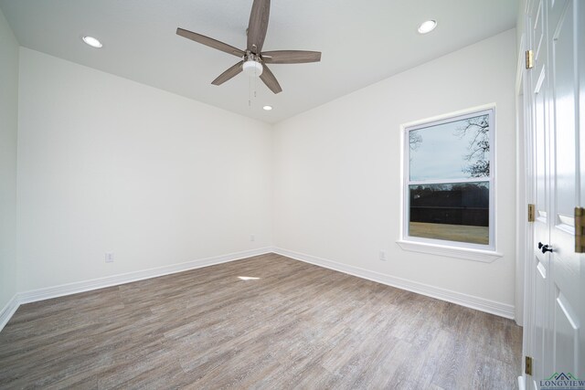 spare room featuring hardwood / wood-style flooring and ceiling fan