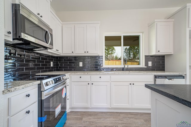 kitchen featuring sink, white cabinetry, and stainless steel appliances