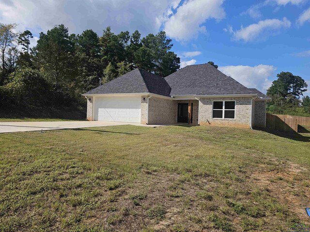 view of front of property featuring a garage and a front lawn