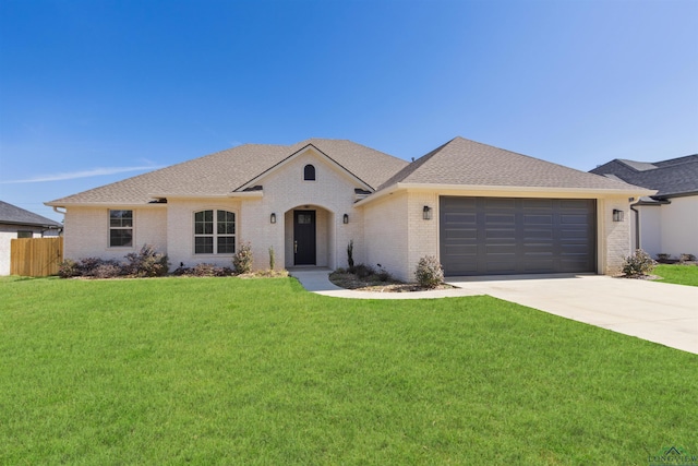 view of front facade featuring a front lawn and a garage