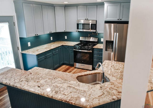 3515 Piping Rock St, Nacogdoches, TX 75965 - kitchen with stainless steel appliances, light wood-type flooring, light stone counters, and recessed lighting