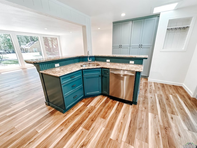 3515 Piping Rock St, Nacogdoches, TX 75965 - kitchen featuring stainless steel dishwasher, light wood-style flooring, light stone countertops, and an island with sink