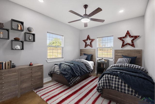 bedroom featuring multiple windows, carpet floors, and ceiling fan