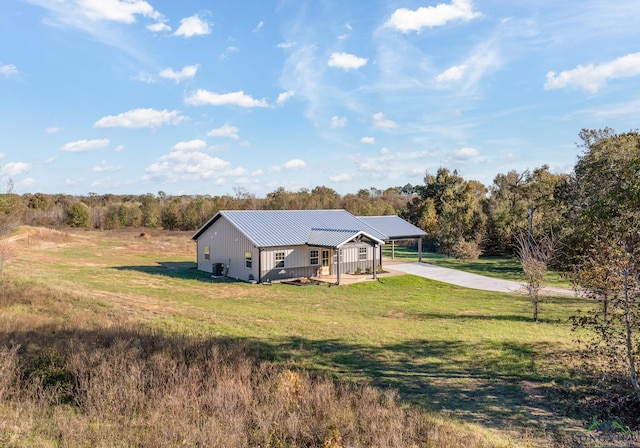 view of front facade featuring a carport, a front yard, and a deck