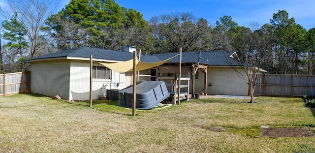 rear view of house with a yard and central air condition unit