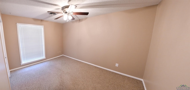 spare room featuring ceiling fan, carpet floors, and a textured ceiling