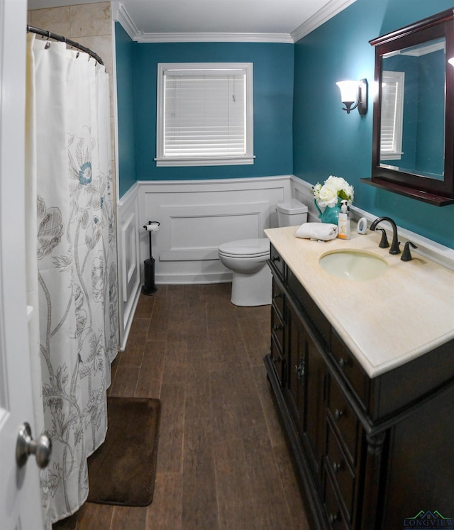 bathroom with crown molding, vanity, toilet, and hardwood / wood-style floors