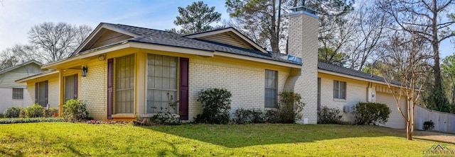 view of side of home with a garage and a yard