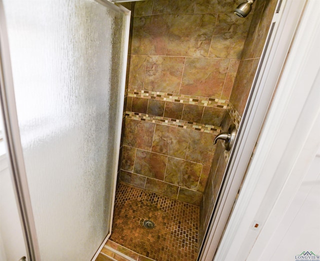 bathroom with tiled shower