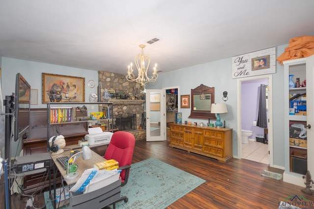 604 Kay Ct, Longview, TX 75601 - office with a chandelier, wood finished floors, and a stone fireplace