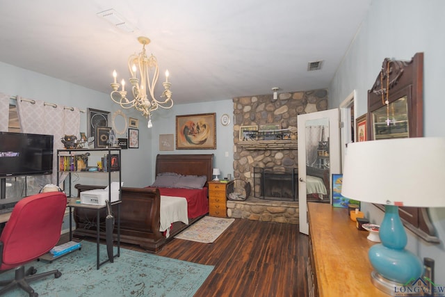 604 Kay Ct, Longview, TX 75601 - bedroom featuring a chandelier, wood finished floors, and a fireplace