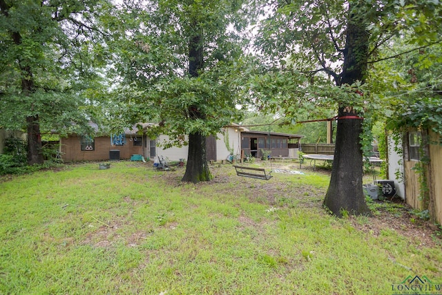 604 Kay Ct, Longview, TX 75601 - view of green lawn with a trampoline