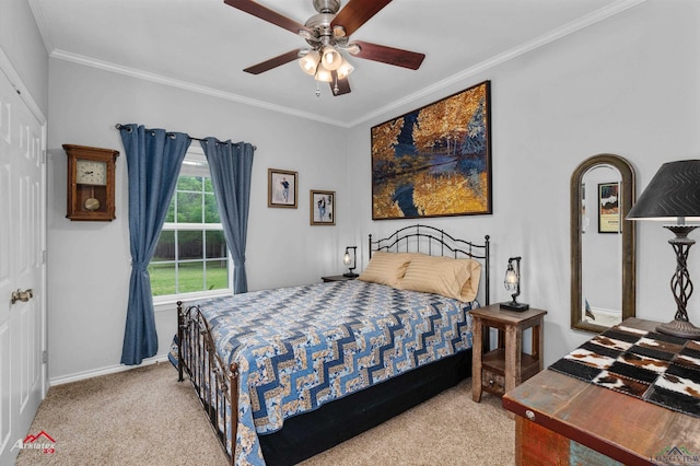 bedroom with carpet floors, baseboards, crown molding, and ceiling fan